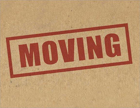 Cardboard box with red "Moving" text stamped to it