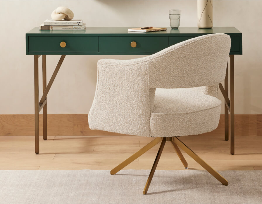 white boucle chair in front of green desk