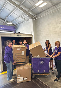 Volunteers loading clothing into the truck