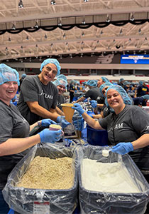 Team packing sugar and oats for homeless