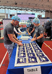 Team packing sugar and oats for homeless