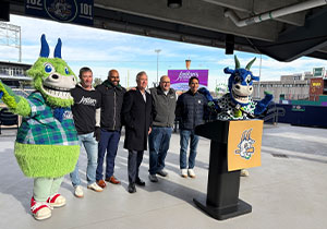 Michael and team taking photo with mascot
