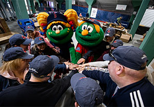 Mascot and Team huddling together before game