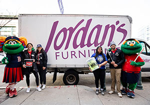 Team and Mascot posing infront of van