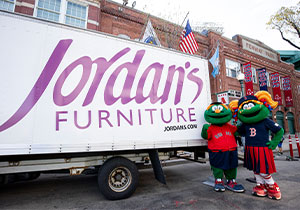 Mr and Mrs mascot posing infront of van