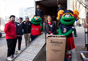 Mascot and team unpacking Amisco dining table
