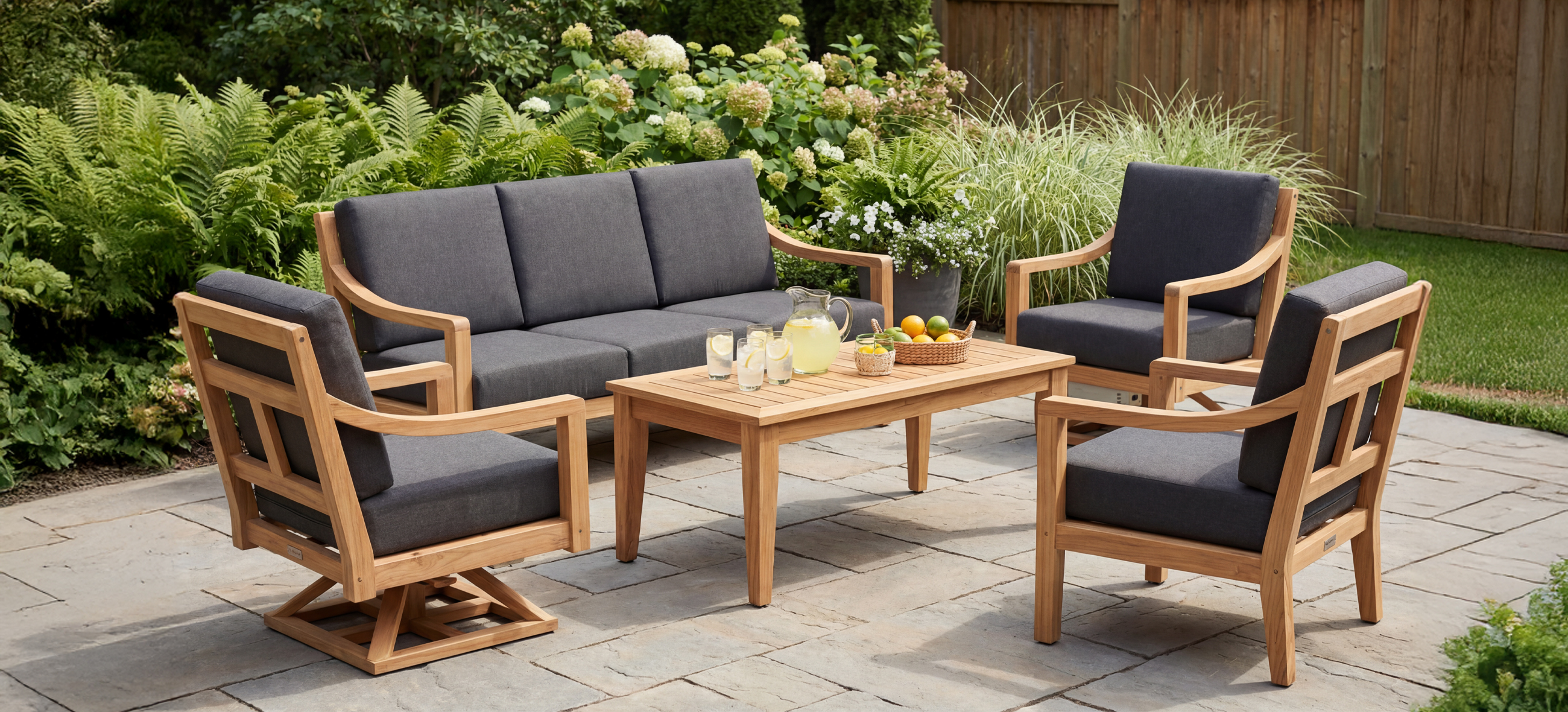 Outdoor Agio Cove dining set with a marble top table and six gray cushioned chairs, overlooking a scenic coastal view.