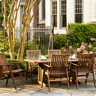 Wooden outdoor table and bench set on a lawn.