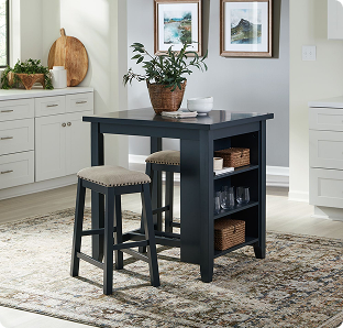A dark navy kitchen island with two cushioned stools and open shelves sits in a bright white kitchen, creating a calm, inviting farmhouse feel.
