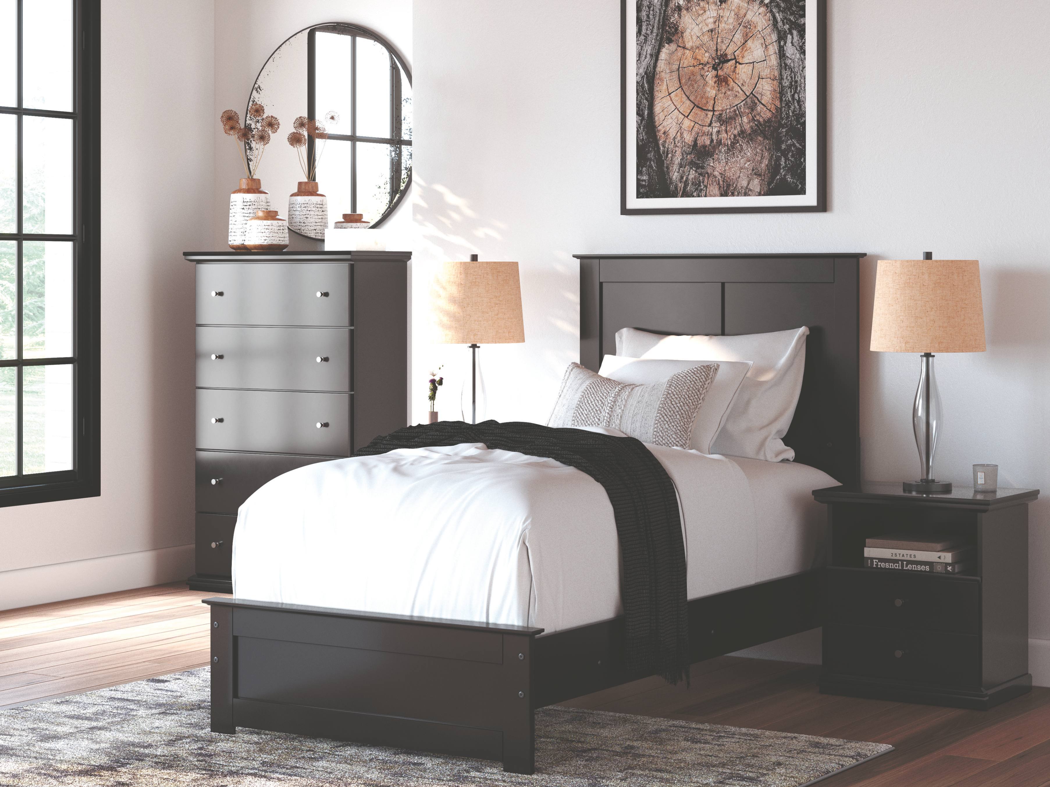 A serene, neutral-toned bedroom features a neatly made bed, matching nightstands and lamps, a dresser with round mirror, framed art, and tall window.